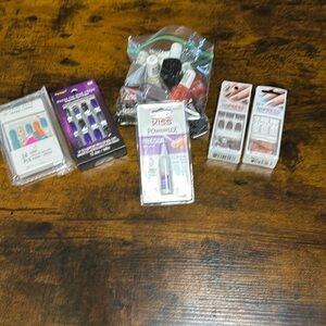 4 packs of press on nails, a new glue never opened and a bag of nail polish